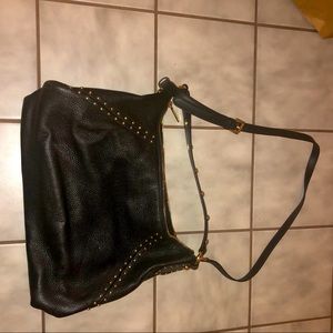 Michael Kors black purse with gold studs.